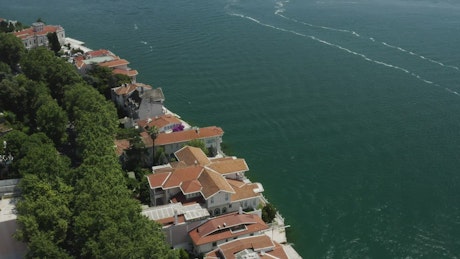 Houses on the shoreline in an aerial shot.