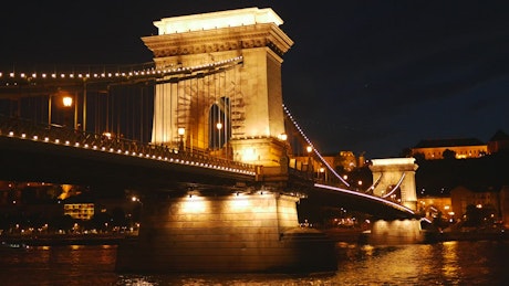 Illuminated bridge at night, time-lapse.
