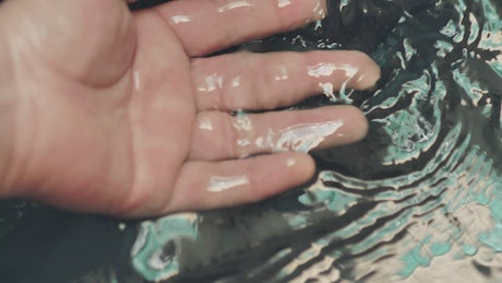 Immersing the hand in water seen in detail