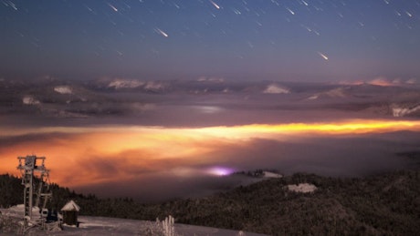 Impressive meteor shower seen from a mountain.