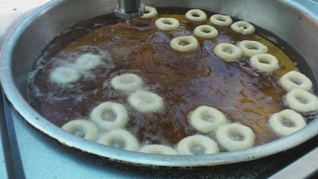 Industrial production of fried donuts.