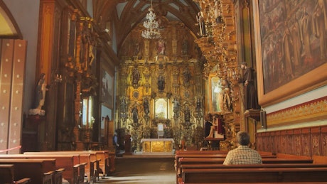 Interior of a baroque church with statues and gilt details