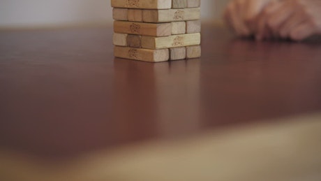 Jenga tower on a table seen in detail.