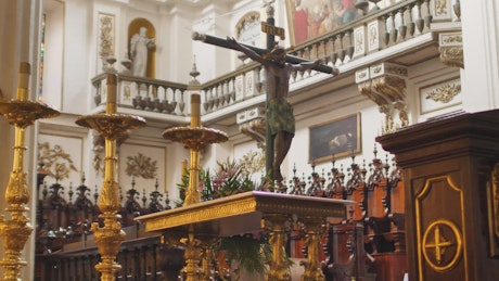Jesus crucified in front of a church behind the pulpit.