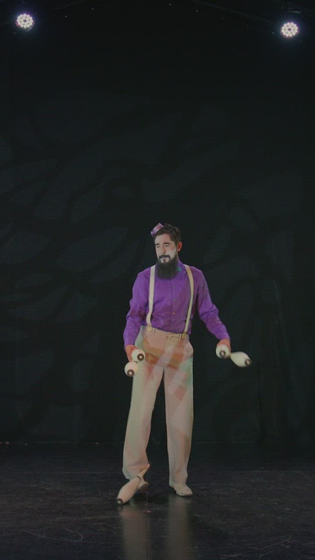 Juggler performing with bowling pins.