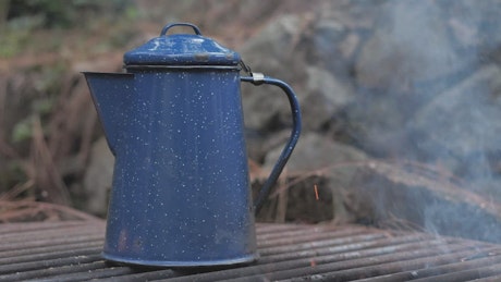Kettle warming up on the campfire.