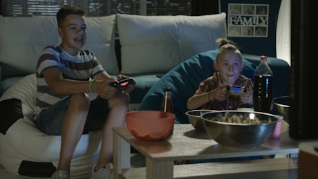 Kids playing video games in the living room