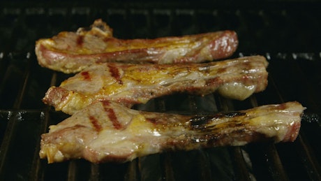 Lamb ribs cooking on a grill