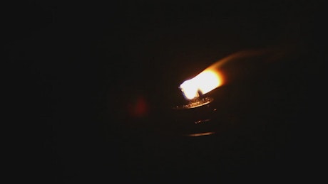 Lamp burning in the wind.