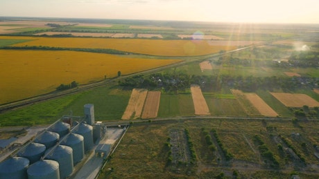 Landscape of agricultural fields and industrial building.
