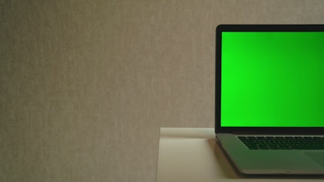 Laptop devise with a green screen.