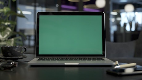 Laptop with a green screen slide in.