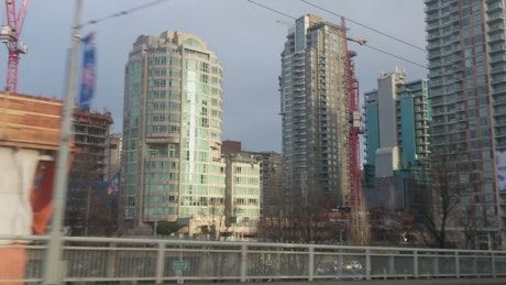 Large buildings from the window of a train.