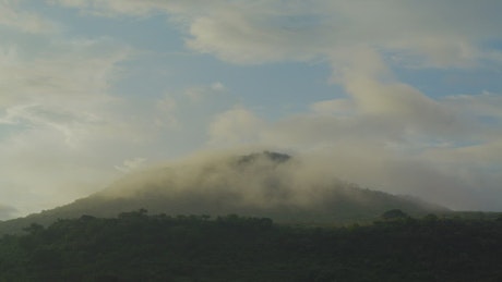 Large hill covered with vegetation in a Timelapse.
