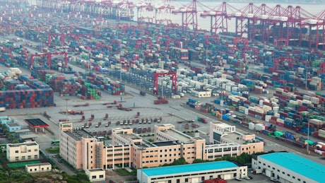 Large warehouse area on a shoreline of ships in a high shot.