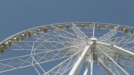Large white ferris wheel at a fairground.