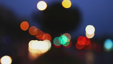 Light particles reflected in a traffic bokeh