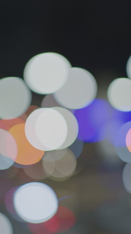 Lights of an avenue at night in a defocused shot.
