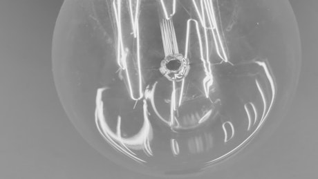 Lit filament reflected in a light bulb