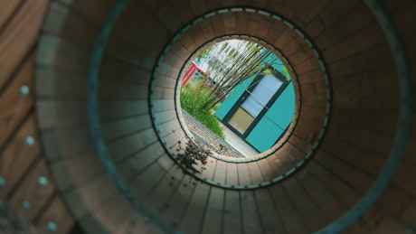 Little boy crossing through a tunnel in a playground.
