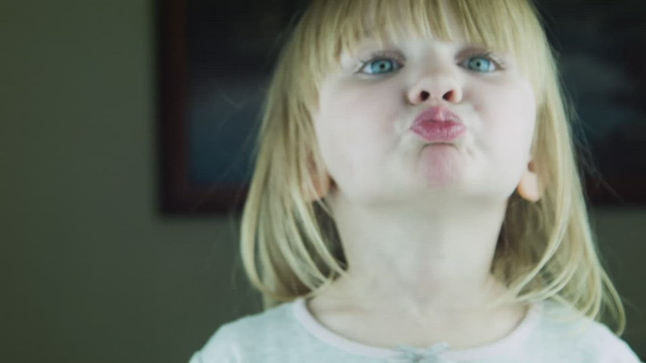 Little cute girl kissing to the camera - Free Stock Video