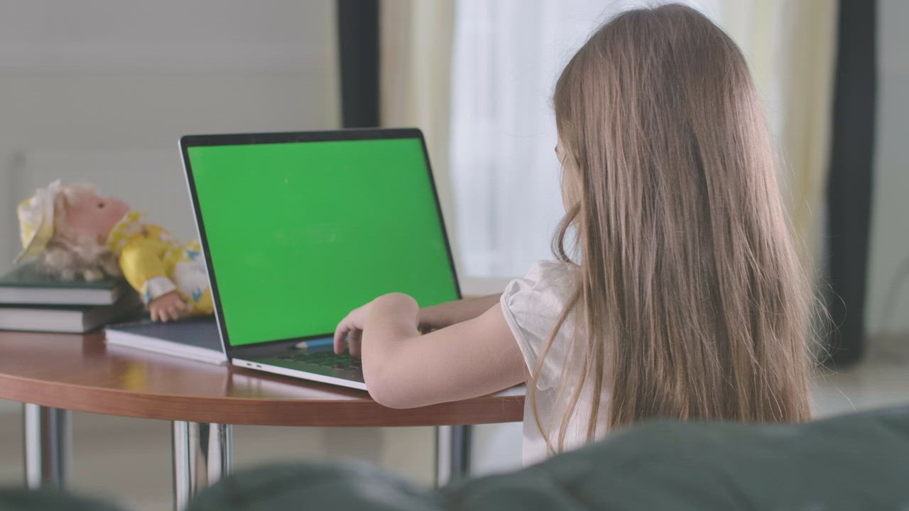 Little girl doing homework on a laptop - Free Stock Video - Mixkit