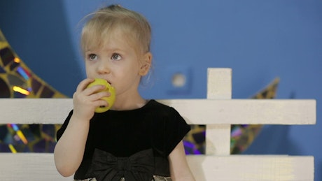 Little girl healthy eating an apple