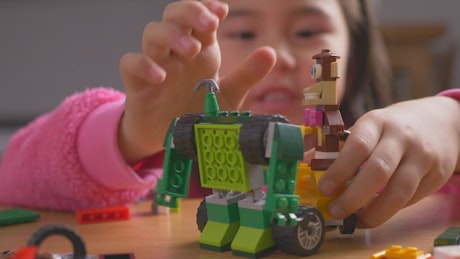 Little girl playing with lego toys.