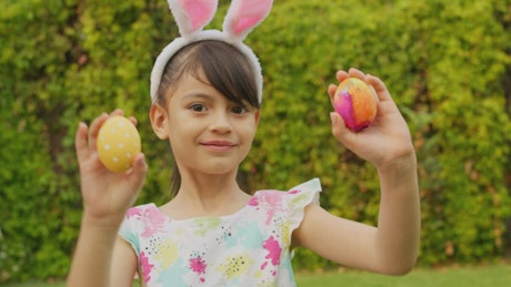 Little girl showing easter eggs.