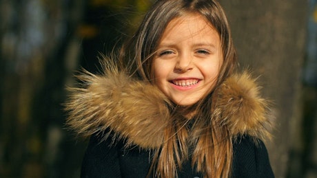 Little girl smiling in a winter coat