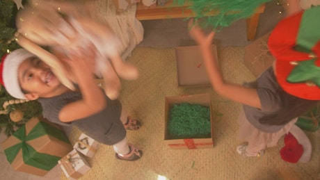 Little sisters playing excited on christmas day.