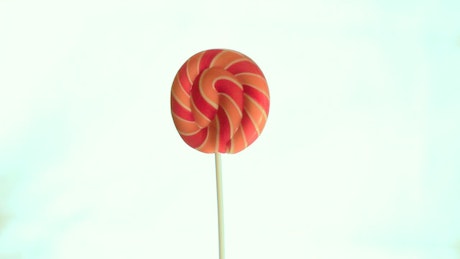 Lollipop spinning against a white background.