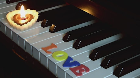 "LOVE" sign on the piano.