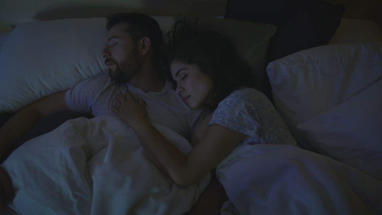 Loving couple sleeping together at night - Free Stock Video