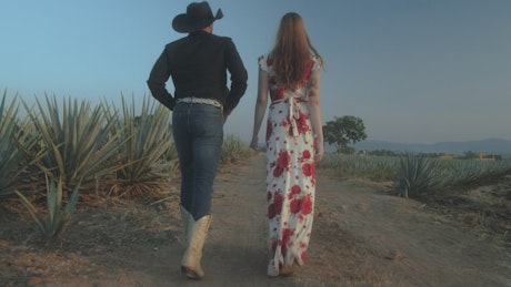 Loving couple walking through a Mexican ranch
