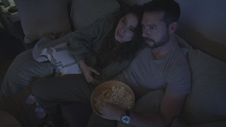 Loving couple watching a movie together.