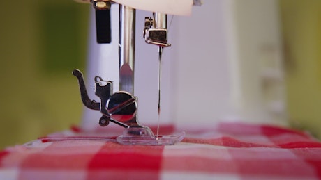 Machine sewing fabric.