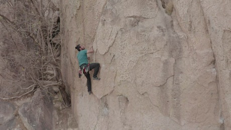 Male alpinist climbing a rocky mountain.