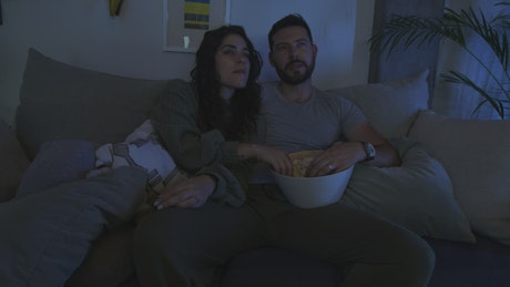 Man and woman watching a movie together