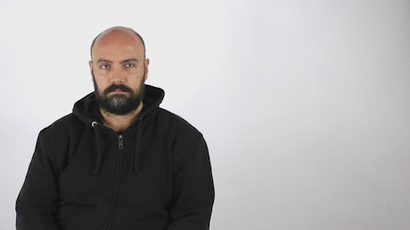 Man answers a call on a white background.