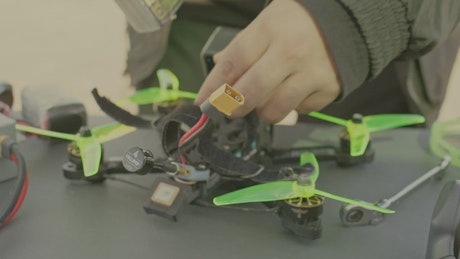 Man assembling a sophisticated homemade drone.