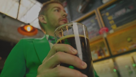 Man celebrating saint patrick's day with a beer.