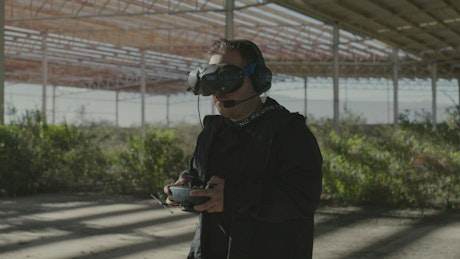 Man controlling a drone with sophisticated technology.