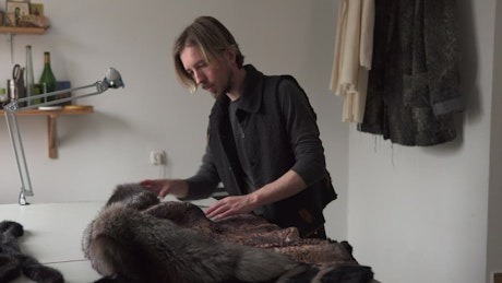 Man creating a fur coat.