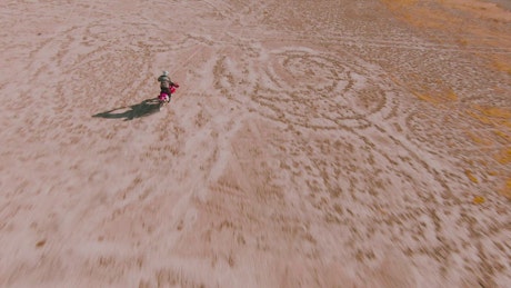 Man crossing the desert on his motorcycle