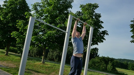 Man doing pull ups in the park
