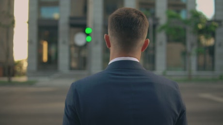 Man dressed in suit crossing the street