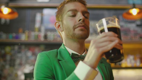 Man drinking beer in a bar on st patrick's day.