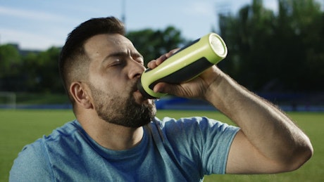 Man drinking water after exercise.