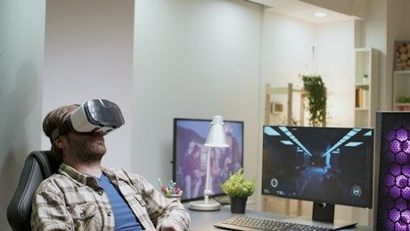 Man enjoys virtual gaming in home office